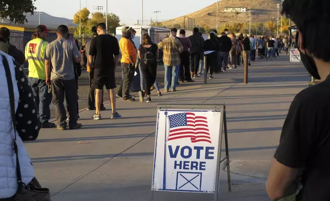 FILE - People wait to vote in-person at Reed High School in Sparks, Nev., prior to polls closing on Nov. 3, 2020. (AP Photo/Scott Sonner, File)