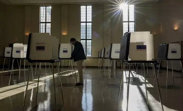 FILE - A voter fills out their Ohio primary election ballot at a polling location in Knox Presbyterian Church in Cincinnati, Ohio, on Tuesday, March 19, 2024. (AP Photo/Carolyn Kaster, File)