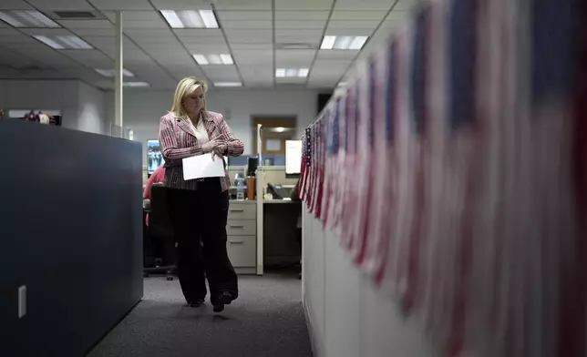 FILE - Cari-Ann Burgess, interim registrar of voters for Washoe County, Nev., walks through the office Sept. 20, 2024, in Reno, Nev. (AP Photo/John Locher, File)