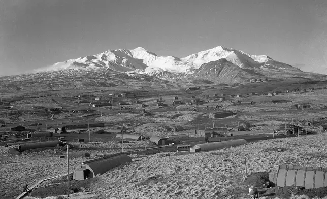 FILE - This is a general view of the Army's task force Williwaw camp on Alaska's Adak Island, shown Feb. 3, 1947, with Mount Moffett in background. The Quonset huts were dug in as protection against the winds. (AP Photo/Joseph D. Jamieson, File)