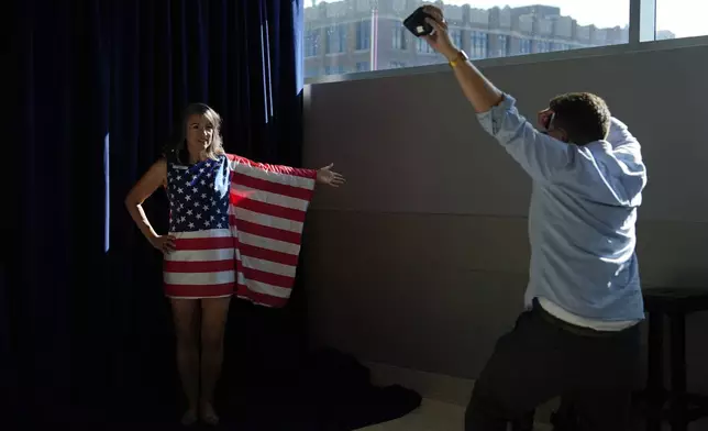 FILE - A person in American flag poses for pictures during the Republican National Convention Thursday, July 18, 2024, in Milwaukee. (AP Photo/Julia Nikhinson, File)