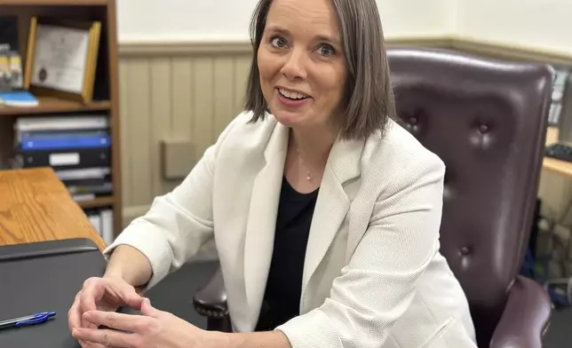 FILE - Maine Democratic Secretary of State Shenna Bellows speaks with an aide in her office after the House voted down an attempt to impeach her on Tuesday, Jan. 9, 2024, in Augusta, Maine. (AP Photo/David Sharp, File)