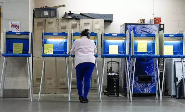 FILE - A voter casts her ballot, April 2, 2024, in Milwaukee, Wis. (AP Photo/Morry Gash, File)