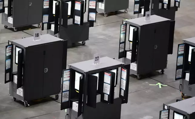 FILE - Voting machines fill the floor for early voting at State Farm Arena, Oct. 12, 2020, in Atlanta. (AP Photo/Brynn Anderson, File)