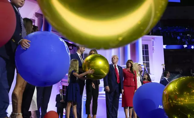 FILE - Republican presidential candidate former President Donald Trump, center, stands on stage with Melania Trump and other members of his family during the Republican National Convention, July 18, 2024, in Milwaukee. (AP Photo/Julia Nikhinson, File)