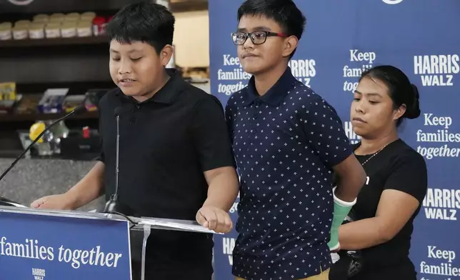 FILE- Christian and Hamilton, no last name given, speak during a Democratic Party campaign event about their experience on being separated from their mother Clairet when they crossed the U.S.- Mexico border during the Trump administration, Oct. 16, 2024, in Doral, Fla. (AP Photo/Marta Lavandier, File)