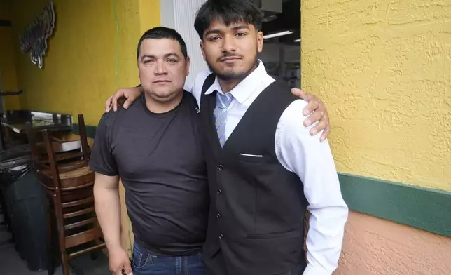 FILE - Billy and his father, no last name given, pause after speaking at a Democratic Party campaign event about their experience of being separated at the U.S.- Mexico border during the Trump administration, Oct. 16, 2024, in Doral, Fla. (AP Photo/Marta Lavandier, File)