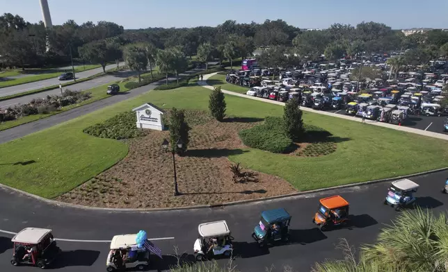 Hundreds of supporters of Democratic presidential nominee Vice President Kamala Harris participate in a golf cart parade to deliver their completed mail-in ballots, in The Villages, Fla., Monday, Oct. 14, 2024. The Villages, one of the world's largest retirement communities, has long been known as a conservative stronghold, but Democrats energized by Harris' candidacy have quietly become more visible. (AP Photo/Rebecca Blackwell)