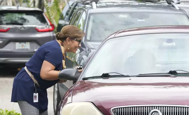 Employees from the Miami-Dade Supervisor of Elections collect mail-in ballots, Wednesday, Oct. 16, 2024, in Doral, Fla. (AP Photo/Marta Lavandier)