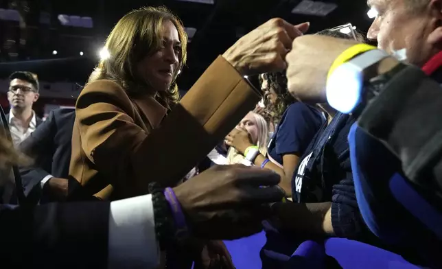 Democratic presidential nominee Vice President Kamala Harris fist-bumps a supporter after speaking at a campaign rally at the Wings Event Center in Kalamazoo, Mich. (AP Photo/Jacquelyn Martin)