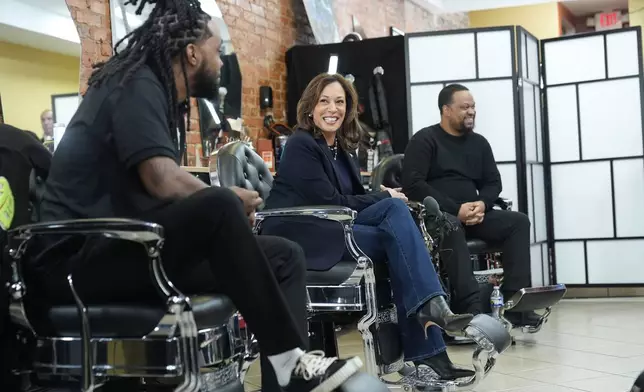 Democratic presidential nominee Vice President Kamala Harris, center, sits in conversation with Black men at Philly Cuts barbershop during a campaign stop, Sunday, Oct. 27, 2024, in Philadelphia. (AP Photo/Susan Walsh)