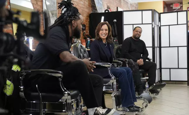 Democratic presidential nominee Vice President Kamala Harris, center, sits in conversation with Black men at Philly Cuts barbershop during a campaign stop, Sunday, Oct. 27, 2024, in Philadelphia. (AP Photo/Susan Walsh)