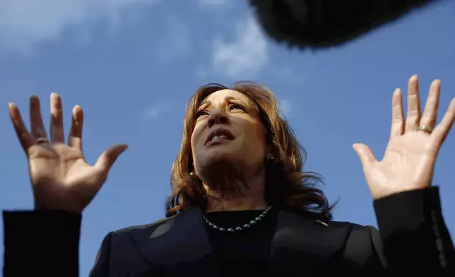 Democratic presidential nominee Vice President Kamala Harris speaks to reporters before boarding Air Force Two to depart for New York at Joint Base Andrews, Md., Monday, Oct. 7, 2024. (Evelyn Hockstein/Pool via AP)