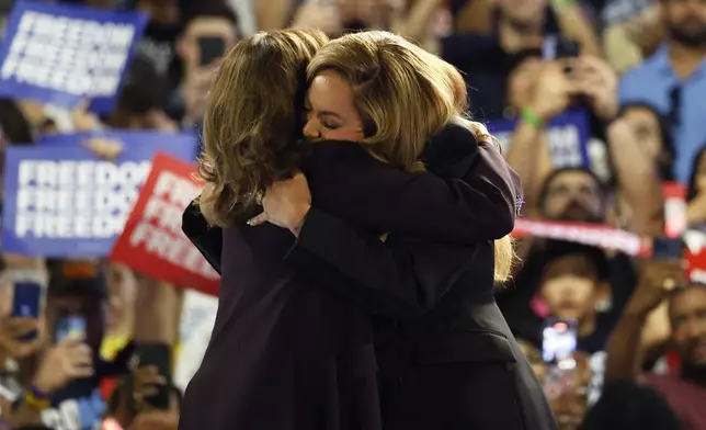 Musical artist Beyonce, right, and Democratic presidential nominee Vice President Kamala Harris, left, embrace on stage during a campaign rally Friday, Oct. 25, 2024, in Houston. (AP Photo/Annie Mulligan)