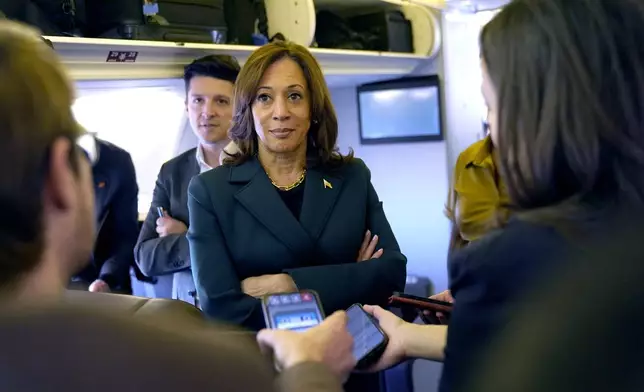 Democratic presidential nominee Vice President Kamala Harris speaks with members of the press on board Air Force Two at Philadelphia International Airport, Monday, Oct. 21, 2024, in Philadelphia, before departing to Michigan. (AP Photo/Jacquelyn Martin, Pool)