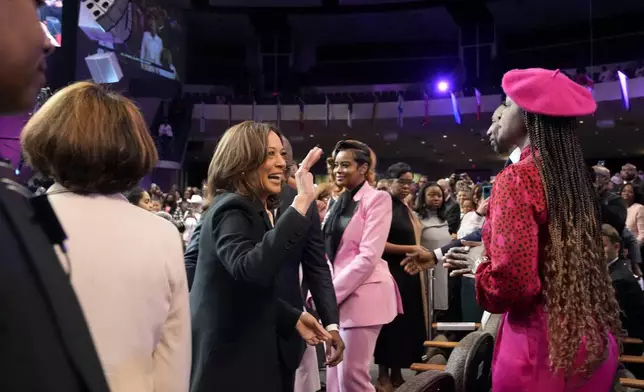 Democratic presidential nominee Vice President Kamala Harris waves to the congregation as she arrives to speak at a church service at New Birth Baptist Church in Stonecrest, Ga., Sunday, Oct. 20, 2024. (AP Photo/Jacquelyn Martin)