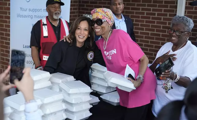 Democratic presidential nominee Vice President Kamala Harris poses for a photo as she helps distribute food with the American Red Cross at the Henry Brigham Community Center in Augusta, Ga., Wednesday, Oct. 2, 2024. (AP Photo/Carolyn Kaster)