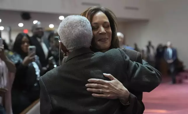 Democratic presidential nominee Vice President Kamala Harris, right, hugs church elder Joy Hollingshed during a service at the Church of Christian Compassion, Sunday, Oct. 27, 2024, in Philadelphia. (AP Photo/Susan Walsh)