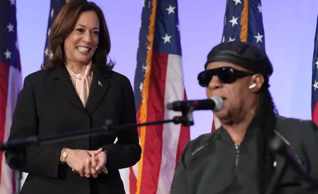 Democratic presidential nominee Vice President Kamala Harris looks on as Stevie Wonder sings "Happy Birthday" to Harris during a church service and early vote event at Divine Faith Ministries International, Sunday, Oct. 20, 2024, in Jonesboro, Ga. (AP Photo/Jacquelyn Martin)