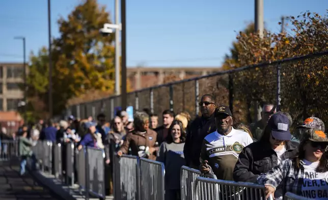 People wait in line to attend a Democratic presidential nominee Vice President Kamala Harris campaign event in Philadelphia, Sunday, Oct. 27, 2024. (AP Photo/Matt Rourke)