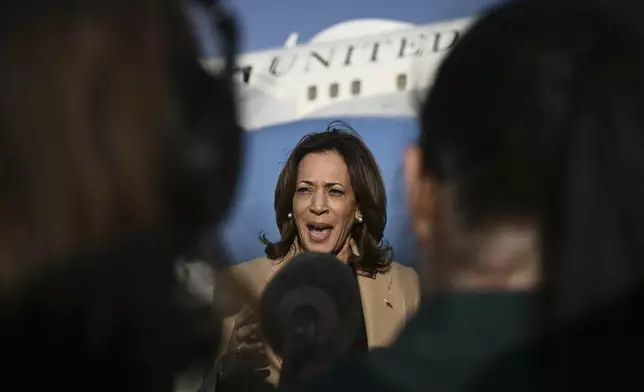 Democratic presidential nominee Vice President Kamala Harris speaks to the press before boarding Air Force Two at Joint Base Andrews, Md., Saturday, Oct. 12, 2024, en route to North Carolina for a campaign event. (Brendan Smialowski/Pool via AP)