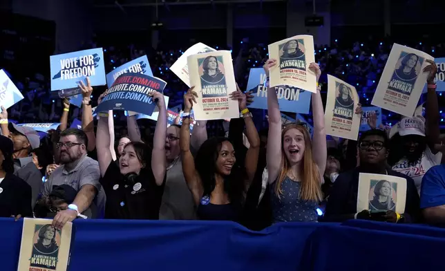 Attendees do the wave as they wait for Democratic presidential nominee Vice President Kamala Harris to speaks at a campaign rally at East Carolina University in Greenville, N.C., Sunday, Oct. 13, 2024. (AP Photo/Susan Walsh)