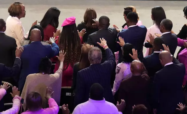 The congregation prays for Democratic presidential nominee Vice President Kamala Harris, top center, at a church service at New Birth Baptist Church in Stonecrest, Ga., Sunday, Oct. 20, 2024. (AP Photo/Jacquelyn Martin)