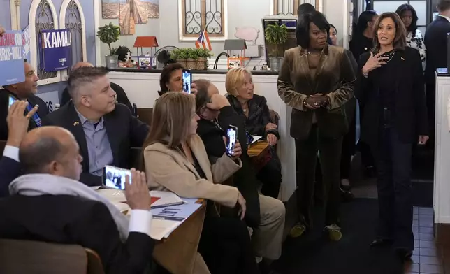 Democratic presidential nominee Vice President Kamala Harris, from right, speaks alongside Philadelphia Mayor Cherelle Parker at Freddy and Tony's restaurant during a campaign stop, Sunday, Oct. 27, 2024, in Philadelphia. (AP Photo/Susan Walsh)