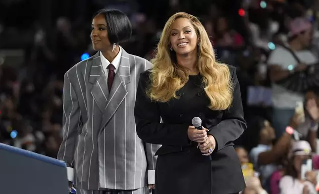 Musical artists Beyonce, right, and Kelly Rowland, left, on stage at a campaign event for Democratic presidential nominee Vice President Kamala Harris in Houston, Friday, Oct. 25, 2024. (AP Photo/Susan Walsh)