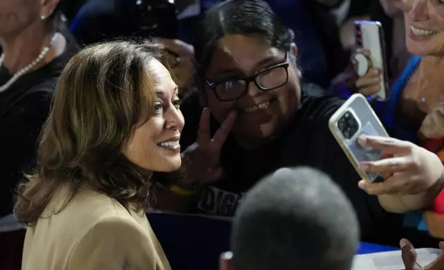 Democratic presidential nominee Vice President Kamala Harris poses for a photo with a supporter after speaking at a campaign event Thursday, Oct. 10, 2024, on the Gila River Indian Community reservation in Chandler, Ariz. (AP Photo/Ross D. Franklin)