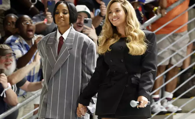 Musical artists Beyonce, right, and Kelly Rowland, left, on stage at a campaign event for Democratic presidential nominee Vice President Kamala Harris, Friday, Oct. 25, 2024, in Houston. (AP Photo/Annie Mulligan)