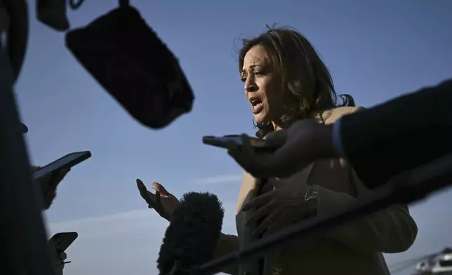 Democratic presidential nominee Vice President Kamala Harris speaks to the press before boarding Air Force Two at Joint Base Andrews, Md., Saturday, Oct. 12, 2024, en route to North Carolina for a campaign event. (Brendan Smialowski/Pool via AP)