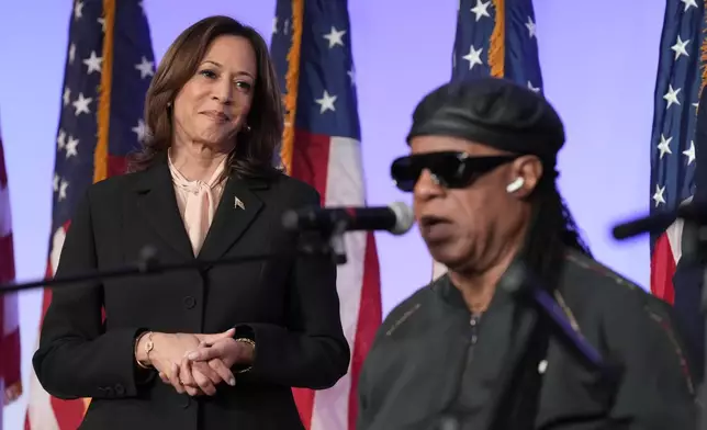 Democratic presidential nominee Vice President Kamala Harris looks on as Stevie Wonder sings "Happy Birthday" to Harris during a church service and early vote event at Divine Faith Ministries International, Sunday, Oct. 20, 2024, in Jonesboro, Ga. (AP Photo/Jacquelyn Martin)