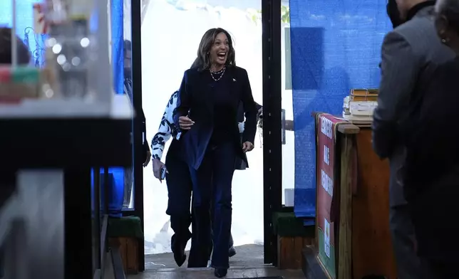 Democratic presidential nominee Vice President Kamala Harris arrives at Hakim's Bookstore and Gift Shop during a campaign stop, Sunday, Oct. 27, 2024, in Philadelphia. (AP Photo/Susan Walsh)