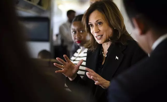 Democratic presidential candidate Vice President Kamala Harris talks to reporters aboard Air Force Two at Joint Base Andrews, Md., Wednesday, Oct. 23, 2024. (Erin Schaff//The New York Times via AP, Pool)