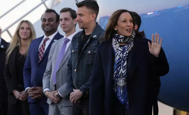 Democratic presidential nominee Vice President Kamala Harris waves at Trenton-Mercer Airport, in Mercer County, N.J., before departing en route to Milwaukee, Wednesday, Oct. 16, 2024. (AP Photo/Jacquelyn Martin)