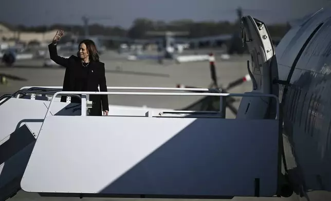 Democratic presidential nominee Vice President Kamala Harris waves as she boards Air Force Two, Wednesday, Oct. 30, 2024, at Joint Base Andrews, Md. (Brendan Smialowski/Pool via AP)