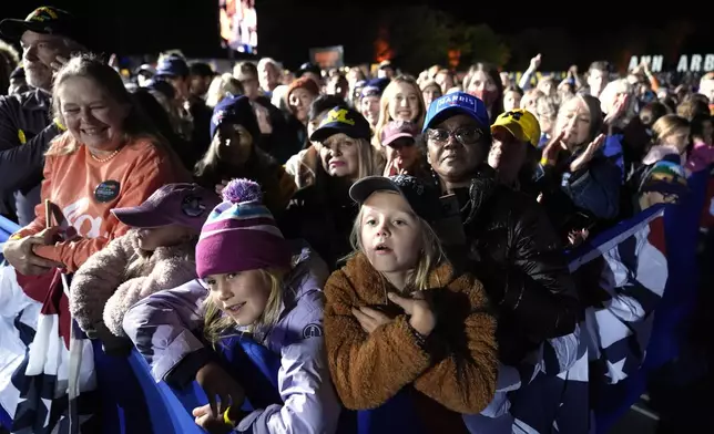 Attendees watch as democratic presidential nominee Vice President Kamala Harris arrives to speak at a campaign event in Burns Park Monday, Oct. 28, 2024, in Ann Arbor, Mich. (AP Photo/Paul Sancya)