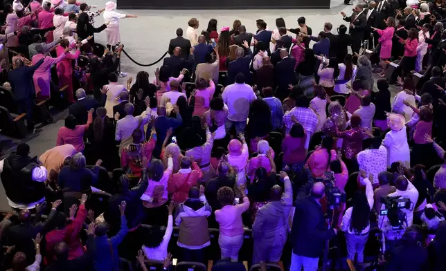 The congregation prays for Democratic presidential nominee Vice President Kamala Harris, top center, at a church service at New Birth Baptist Church in Stonecrest, Ga., Sunday, Oct. 20, 2024. (AP Photo/Jacquelyn Martin)