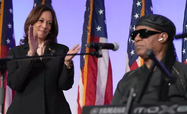 Democratic presidential nominee Vice President Kamala Harris claps after Stevie Wonder sang "Happy Birthday" to Harris during a church service and early vote event at Divine Faith Ministries International, Sunday, Oct. 20, 2024, in Jonesboro, Ga. (AP Photo/Jacquelyn Martin)