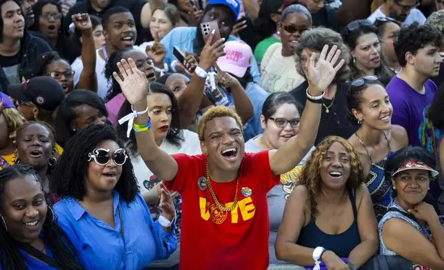 Marcus Gully, center, cheers at a rally for Democratic presidential nominee Vice President Kamala Harris on Friday, Oct. 25, 2024, in Houston. (AP Photo/Annie Mulligan)