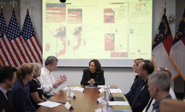 Democratic presidential nominee Vice President Kamala Harris, center right, receives a briefing from North Carolina Gov. Roy Cooper, center left, on the damage from Hurricane Helene, Saturday, October 5, 2024, in Charlotte, N.C. (AP Photo/Chris Carlson)