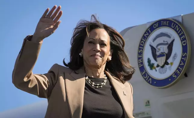 Democratic presidential nominee Vice President Kamala Harris Vice waves as she boards Air Force Two at Philadelphia International Airport in Philadelphia, Thursday, Oct. 24, 2024, en route to Atlanta. (AP Photo/Matt Rourke)