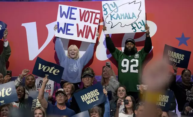 Supporters carry signs before Democratic presidential nominee Vice President Kamala Harris speaks during a community rally at the Alan Horwitz "Sixth Man" Center, Sunday, Oct. 27, 2024, in Philadelphia. (AP Photo/Susan Walsh)