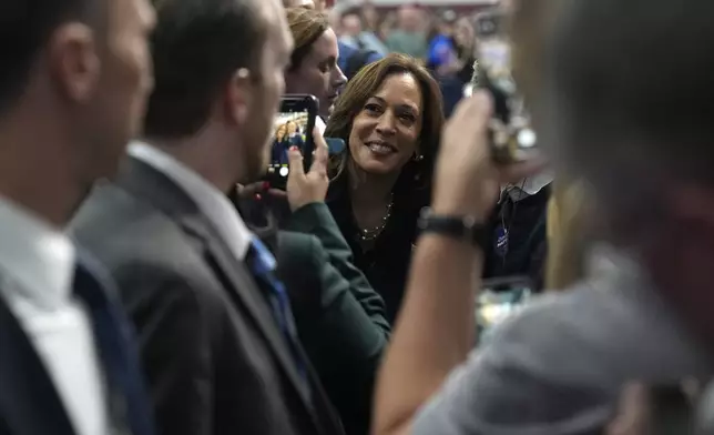 Democratic presidential nominee Vice President Kamala Harris, center, takes a photo with a supporter after speaking at a campaign rally at the University of Wisconsin La Crosse, in La Crosse, Wis., Thursday, Oct. 17, 2024. (AP Photo/Jacquelyn Martin)