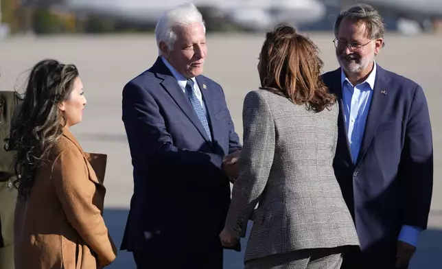 Democratic presidential nominee Vice President Kamala Harris, second from right, is greeted by Sen. Gary Peters, D-Mich., from right, Michigan democratic State Senator Paul Wojno and Michigan State Rep. Mai Xiong, upon arriving at Selfridge Air National Guard Base, Monday, Oct. 28, 2024, in Harrison Township, Mich. (AP Photo/Paul Sancya)