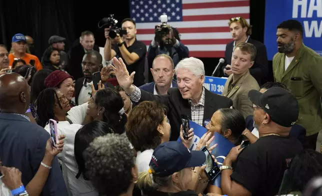 Former President Bill Clinton meets with people after speaking at a campaign event supporting Democratic presidential nominee Vice President Kamala Harris, Tuesday, Oct. 22, 2024, in Las Vegas. (AP Photo/John Locher)