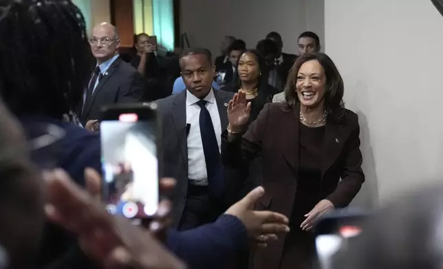 Democratic presidential nominee Vice President Kamala Harris greets attendees as she departs after speaking during a service at the Church of Christian Compassion, Sunday, Oct. 27, 2024, in Philadelphia. (AP Photo/Susan Walsh)