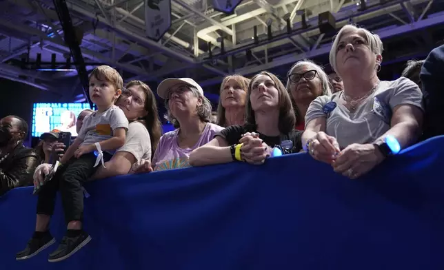 Attendees listen as Democratic presidential nominee Vice President Kamala Harris speaks at a campaign rally at East Carolina University in Greenville, N.C., Sunday, Oct. 13, 2024. (AP Photo/Susan Walsh)