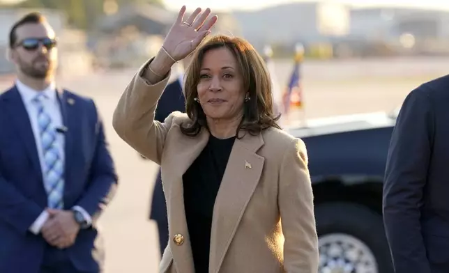 Democratic presidential nominee Vice President Kamala Harris waves as she arrives at Raleigh-Durham International Airport in Morrisville, N.C., Saturday, Oct. 12, 2024. (AP Photo/Steve Helber)